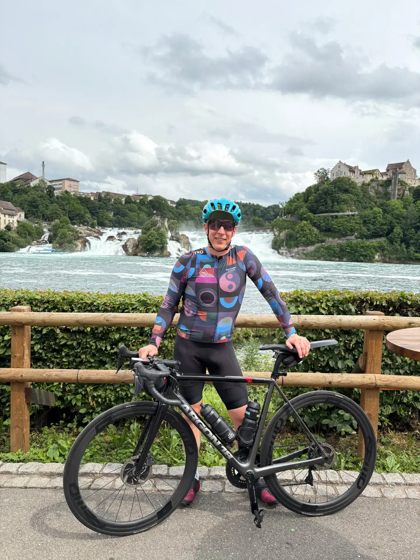Cyclist with a road bike in front of the Rheinfall waterfall near Zurich, Switzerland