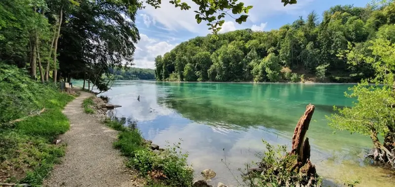 Gravel path beside the turquoise Rhine river near Schaffhausen on a gravel cycling day from Zurich